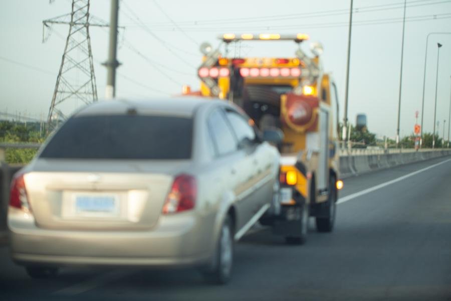 Car being towed away by a tow truck in Newmarket